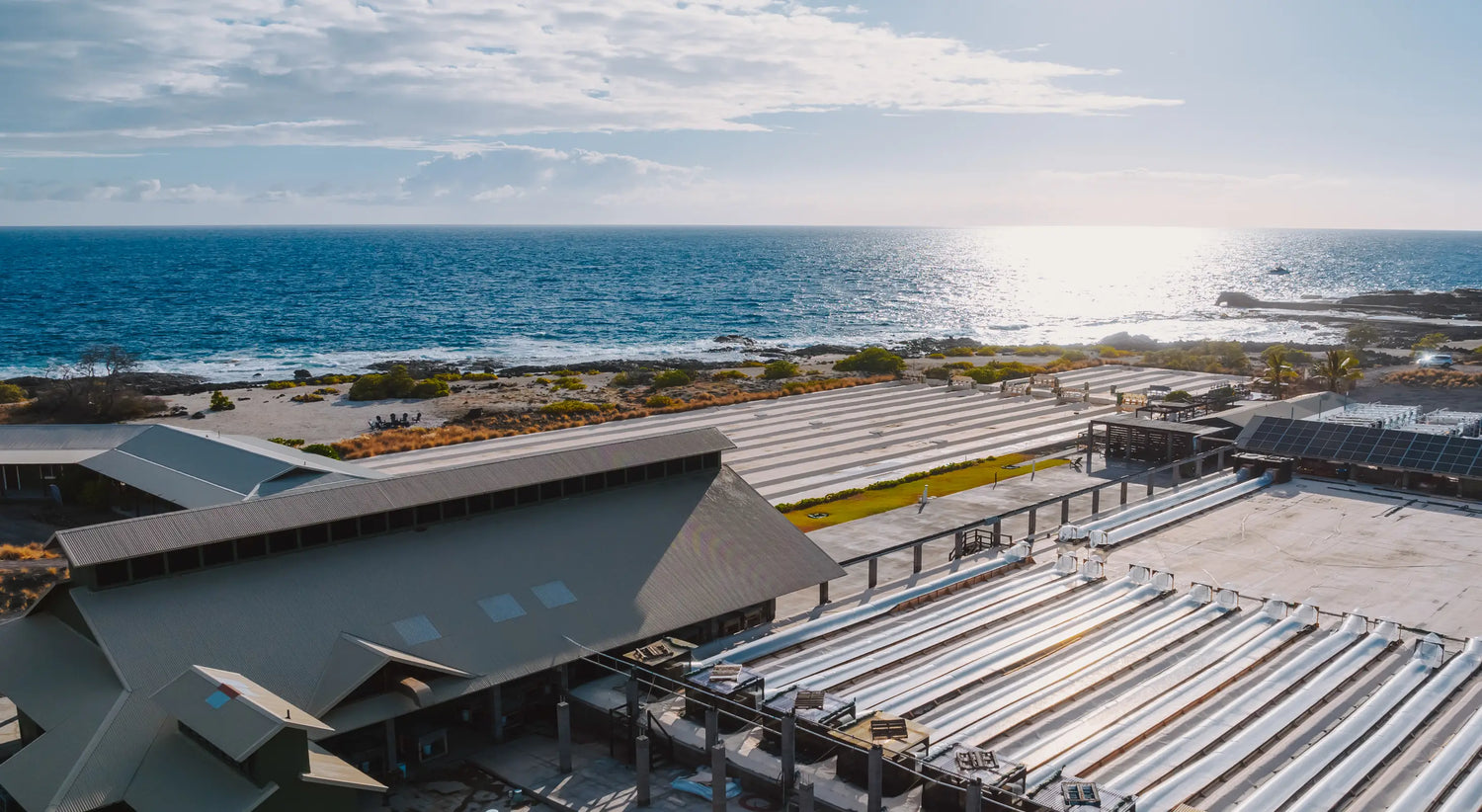 Kona Salt Farm building with a coastal view, featuring ocean and sky.