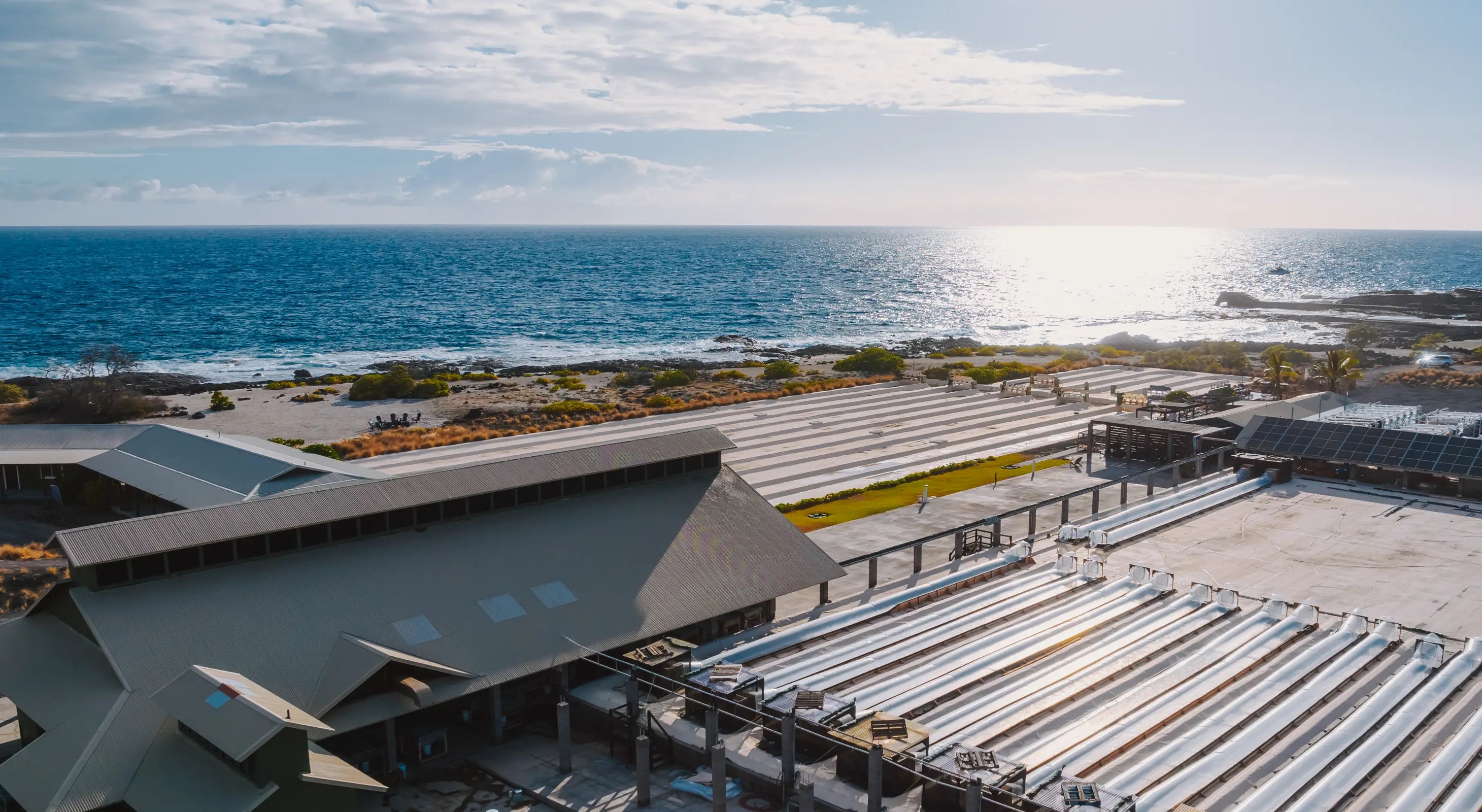 Kona Salt Farm building with a coastal view, featuring ocean and sky.