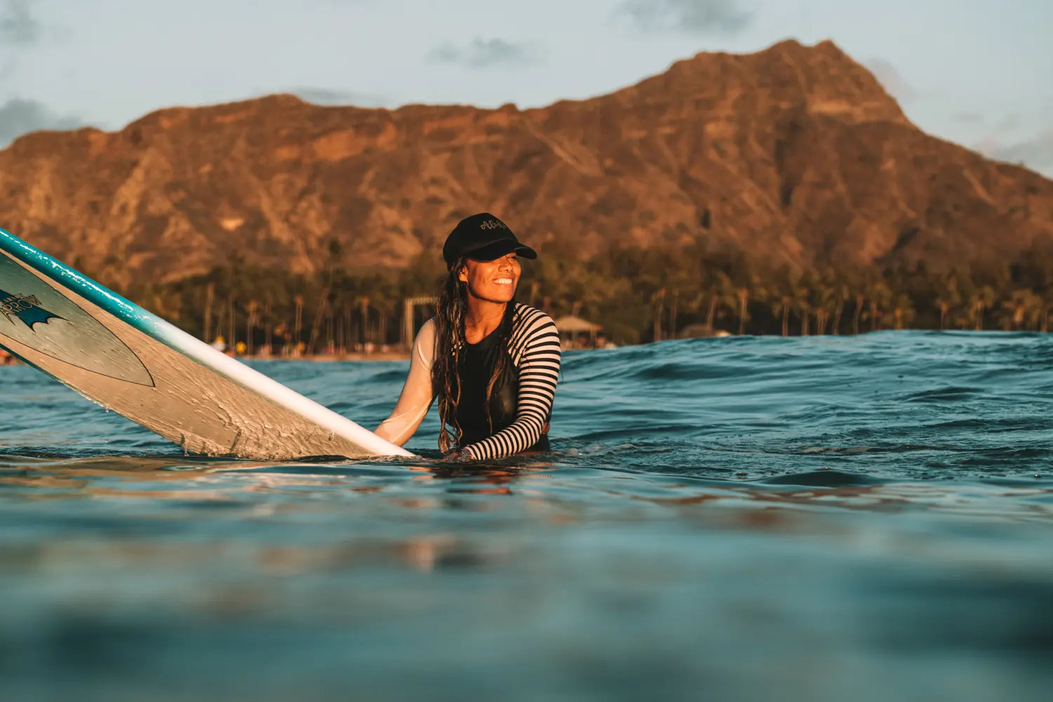 Person sitting on a surfboard at Waikiki